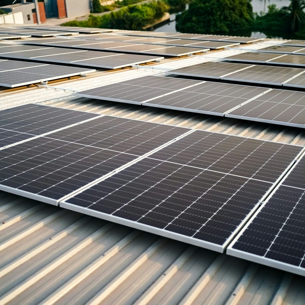 Solar panel installer installing solar panels on roof of warehouse